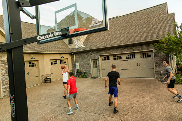 athletes playing on outdoor basketball court