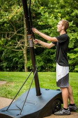 Silverback NXT 50 Portable Basketball Goal - Boy Adjusting Basketball Goal Height