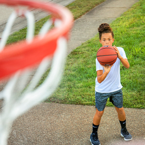 athlete shooting on basketball net