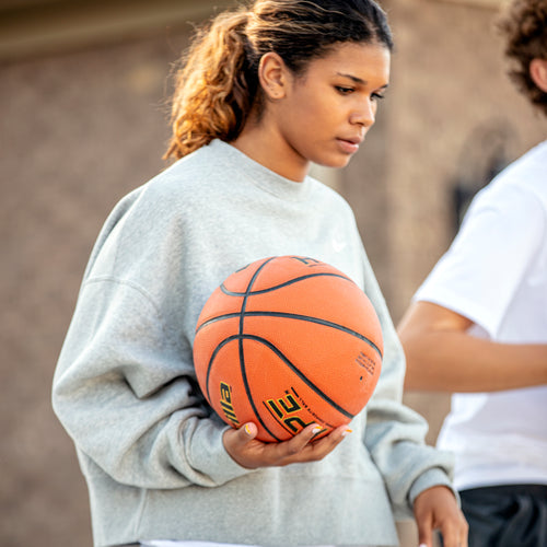 female athlete with basketball in hand