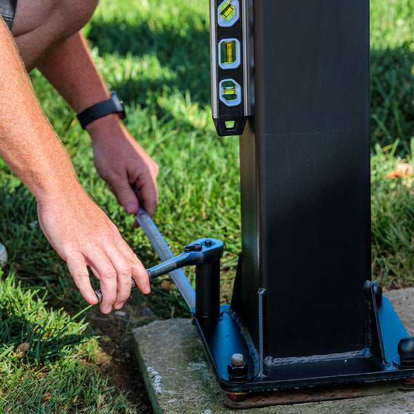 adjusting the bolts on an in ground basketball hoop anchor kit