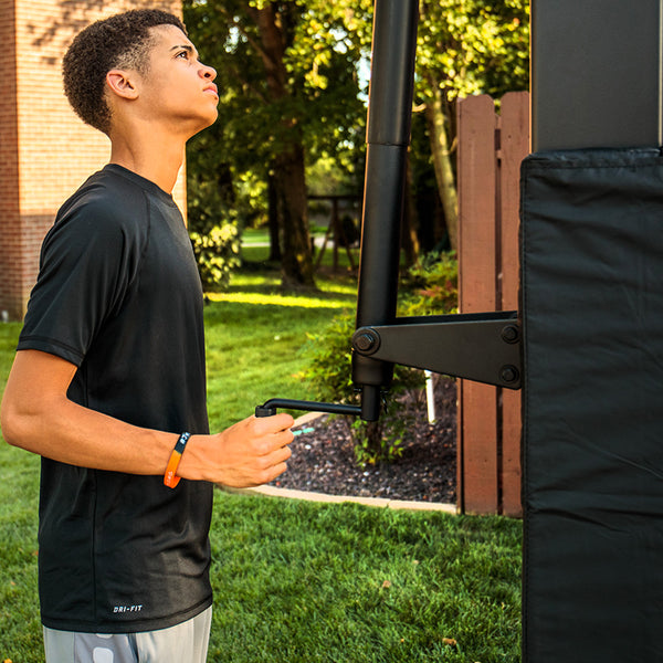 athlete actuating a basketball hoop maintenance - basketball goal maintenance 