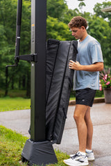 Person setting up a Goalrilla CV60T Tinted Backboard Basketball Hoop in an outdoor setting