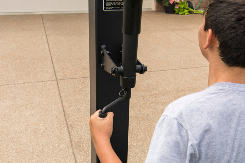 Goalrilla In Ground Basketball Goal - FT72 - 72" Backboard - Boy Adjusting Height with Crank Handle